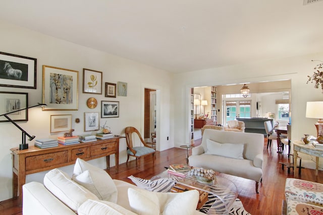 living room with dark hardwood / wood-style flooring and french doors