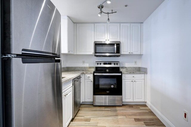 unfurnished room with hardwood / wood-style floors, ornamental molding, and a textured ceiling