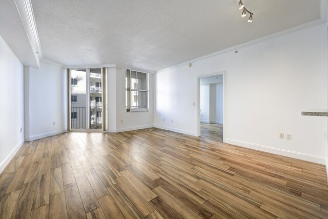 spare room featuring ceiling fan, crown molding, and light hardwood / wood-style flooring