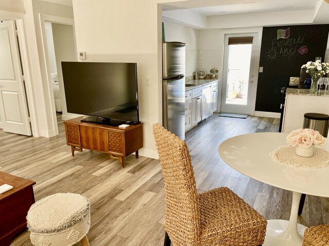 dining space with light hardwood / wood-style floors