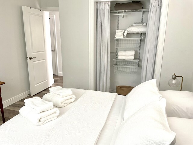 bedroom featuring a closet and dark wood-type flooring