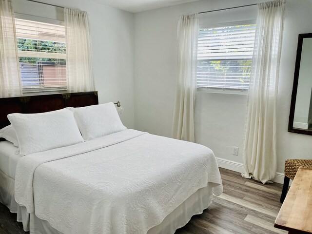 bedroom with hardwood / wood-style flooring