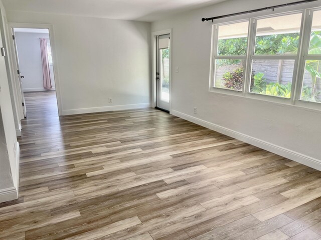 spare room with light hardwood / wood-style flooring