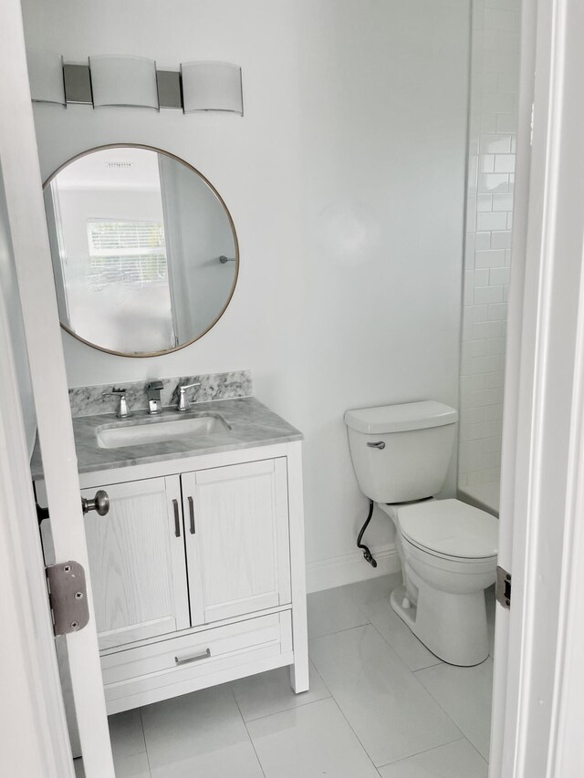 bathroom featuring tile patterned floors, vanity, and toilet