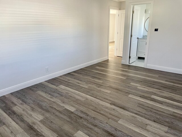 spare room with dark wood-type flooring