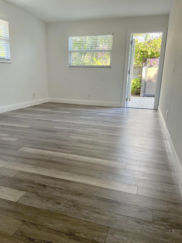 unfurnished room with hardwood / wood-style floors