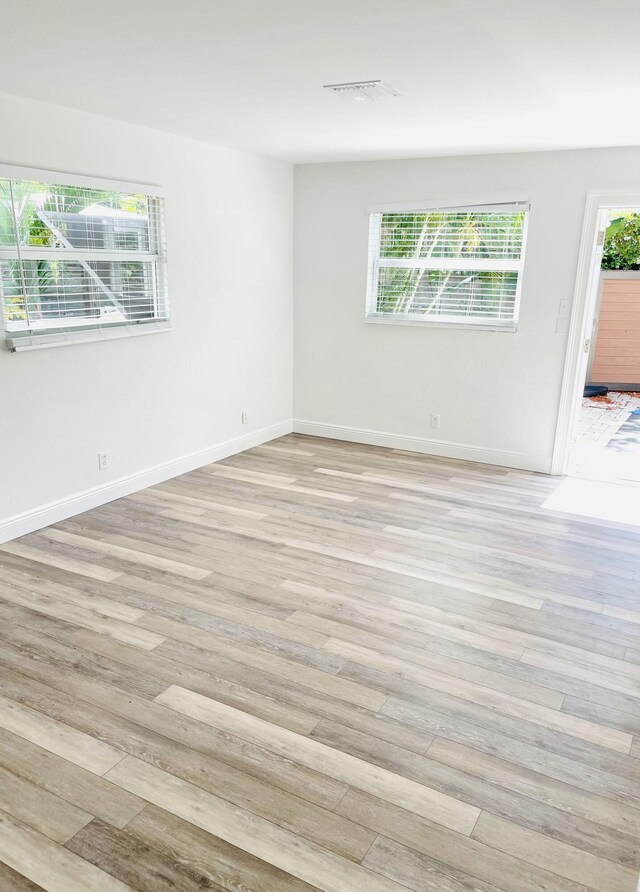 unfurnished room with light hardwood / wood-style flooring