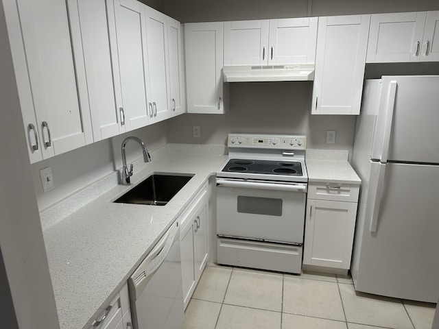 kitchen with sink, white cabinets, light tile patterned flooring, and white appliances