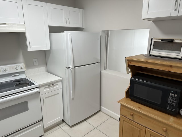 kitchen with white cabinetry, light tile patterned floors, white appliances, and exhaust hood