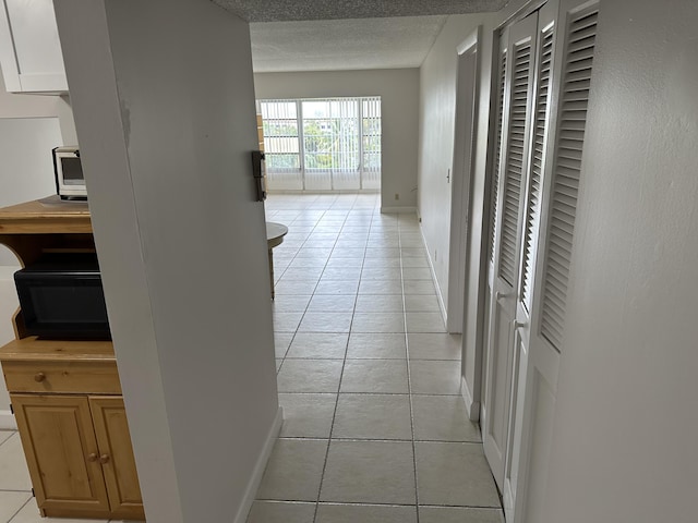 hallway featuring light tile patterned floors