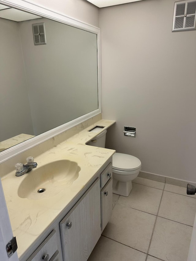 bathroom featuring tile patterned floors, vanity, and toilet