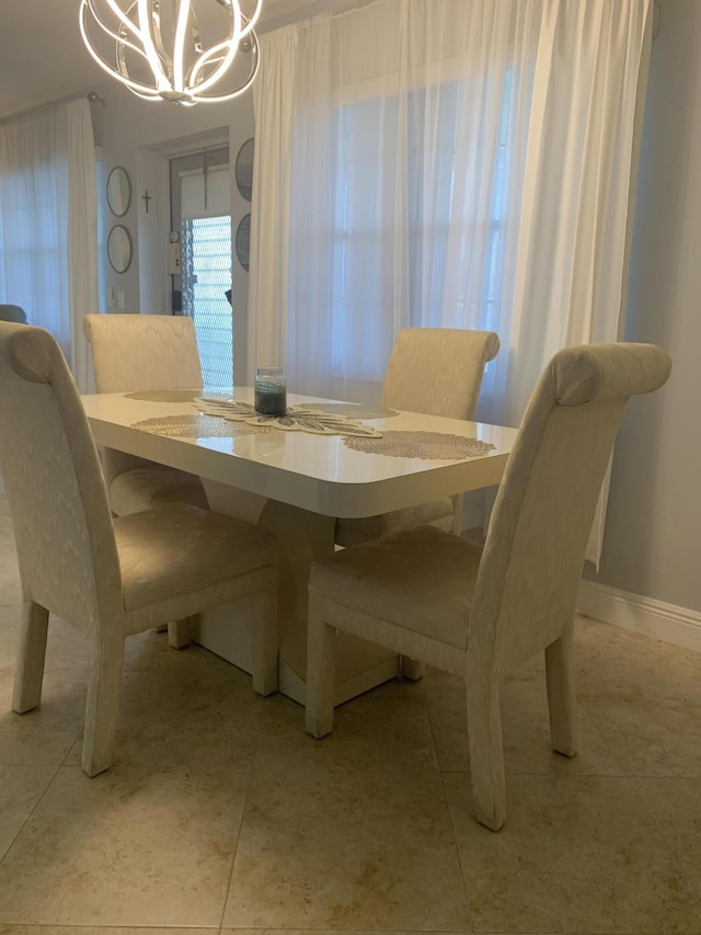 dining space featuring an inviting chandelier and light tile patterned flooring