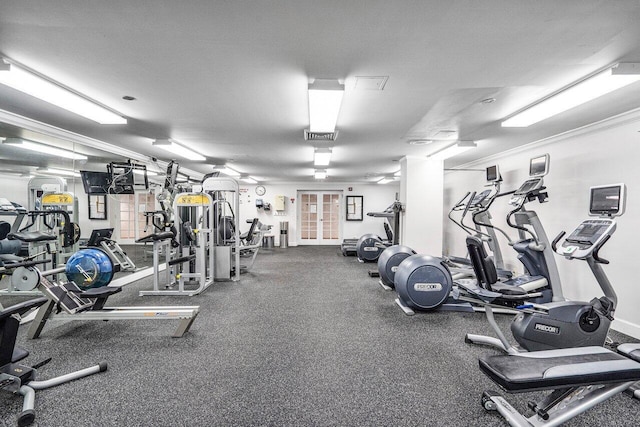 exercise room featuring a textured ceiling and crown molding