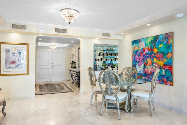 dining space featuring built in features, crown molding, and a chandelier