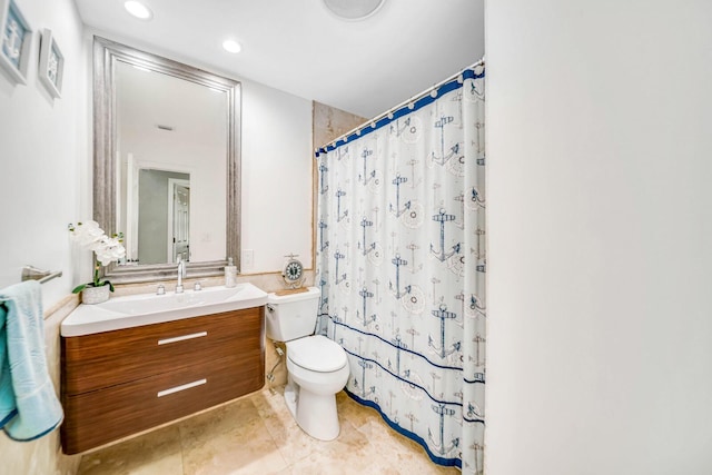 bathroom featuring vanity, toilet, and walk in shower