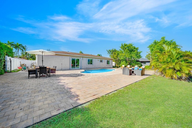 view of pool featuring a yard and a patio