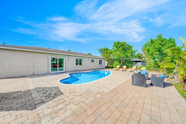 view of swimming pool featuring an outdoor living space and a patio area