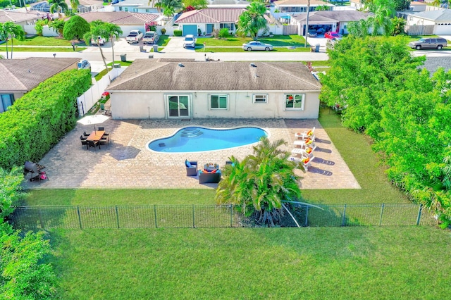 view of swimming pool featuring a patio area and a lawn