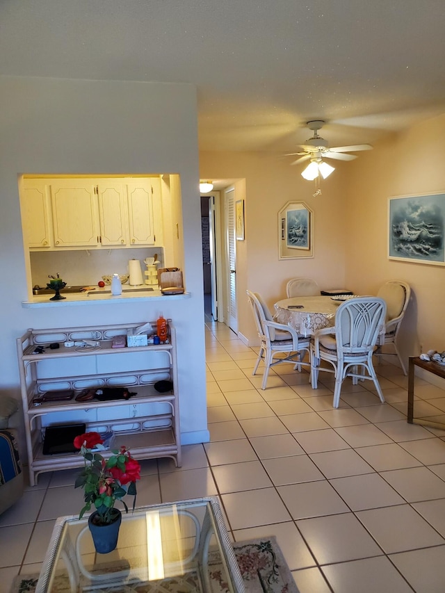 interior space with ceiling fan and light tile patterned flooring