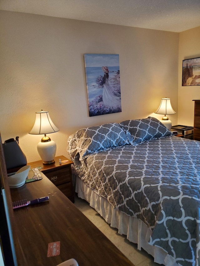 bedroom featuring a textured ceiling and carpet floors