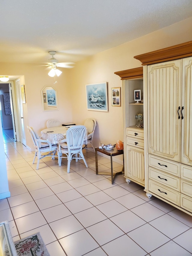 tiled dining area featuring ceiling fan