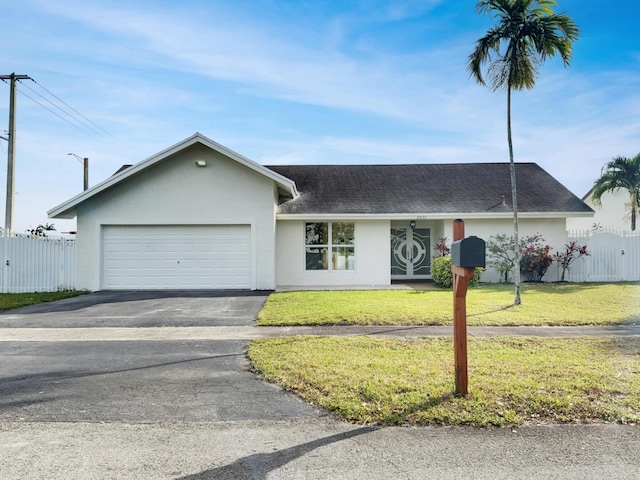 ranch-style home with a garage and a front yard