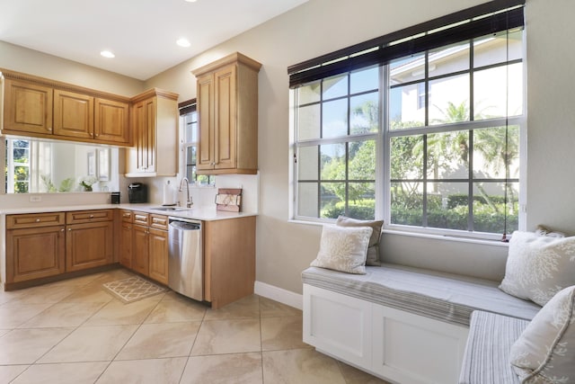 kitchen with sink, light tile patterned floors, and stainless steel dishwasher