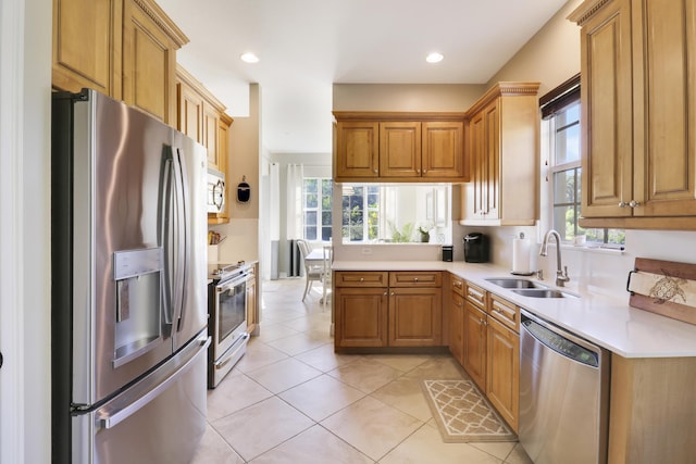 kitchen featuring light tile patterned flooring, appliances with stainless steel finishes, and sink