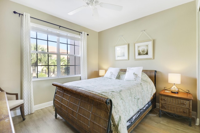 bedroom with ceiling fan and light hardwood / wood-style flooring