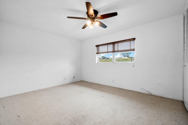 carpeted empty room with ceiling fan