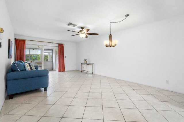 living room with light tile patterned floors and ceiling fan with notable chandelier