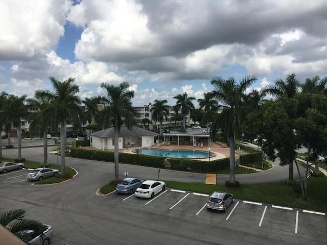 view of vehicle parking featuring a community pool