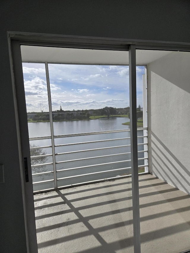 view of dock featuring a water view and a balcony