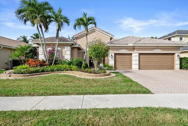 mediterranean / spanish house with a front yard and a garage