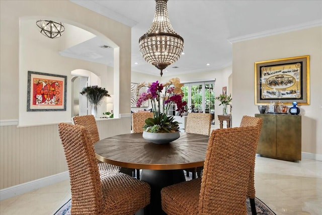 dining space featuring a chandelier and ornamental molding