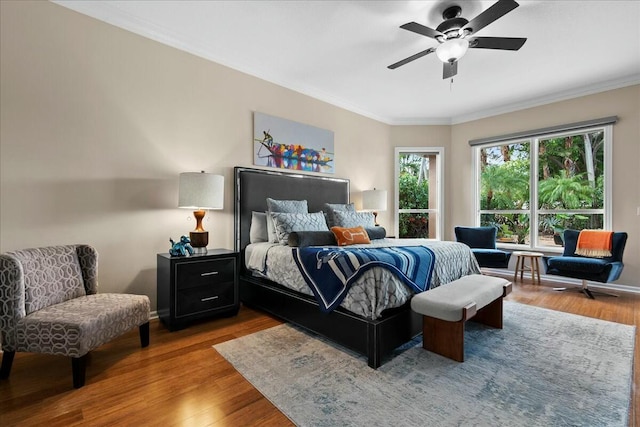 bedroom featuring ceiling fan, wood-type flooring, and ornamental molding