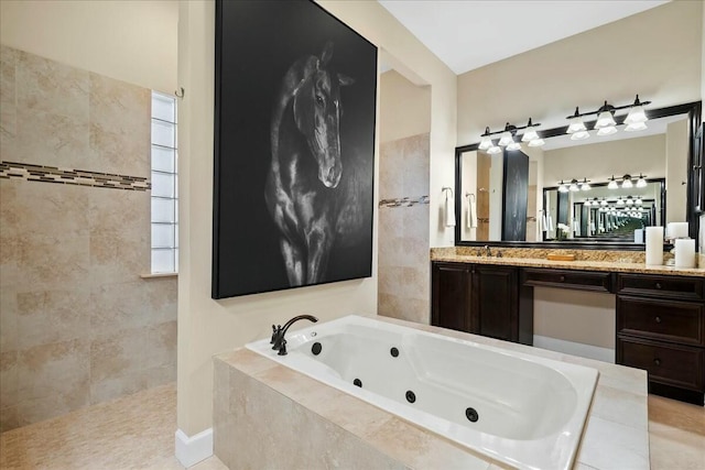 bathroom with vanity and tiled bath