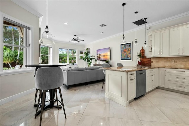 kitchen with white cabinets, a kitchen breakfast bar, decorative light fixtures, and stainless steel dishwasher