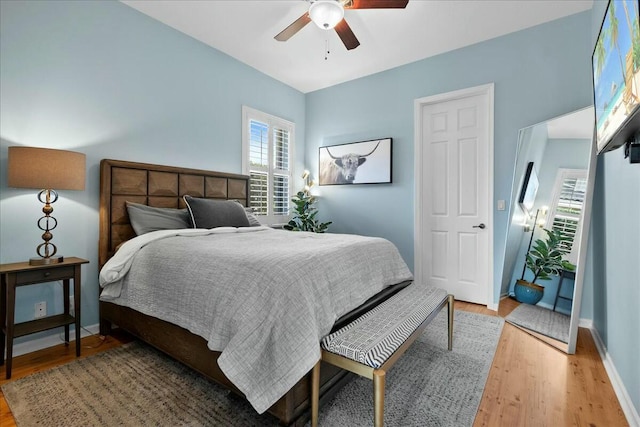 bedroom with ceiling fan and wood-type flooring