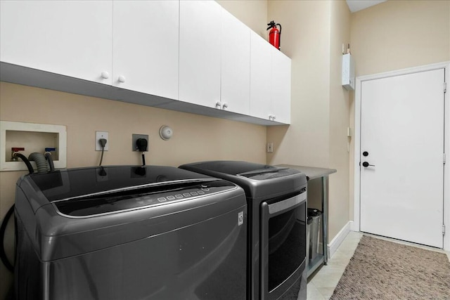 laundry area with cabinets and washing machine and clothes dryer