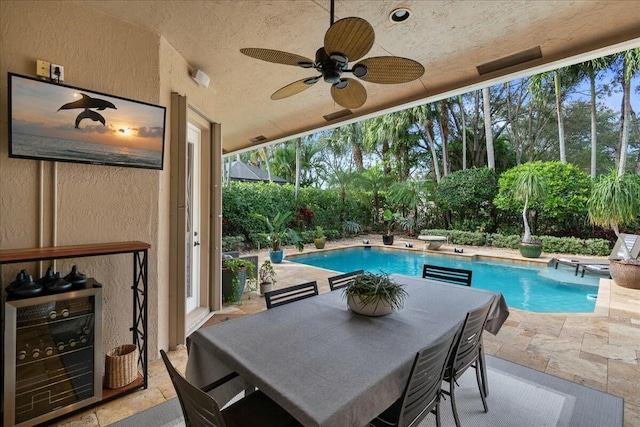 view of swimming pool with ceiling fan and a patio