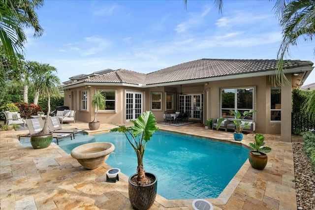 view of pool with french doors and a patio