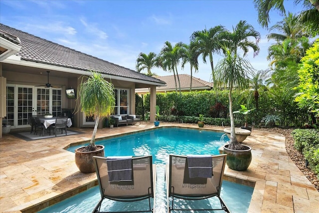 view of swimming pool featuring a patio and ceiling fan