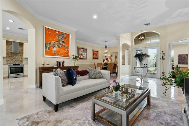 living room featuring a chandelier and ornamental molding