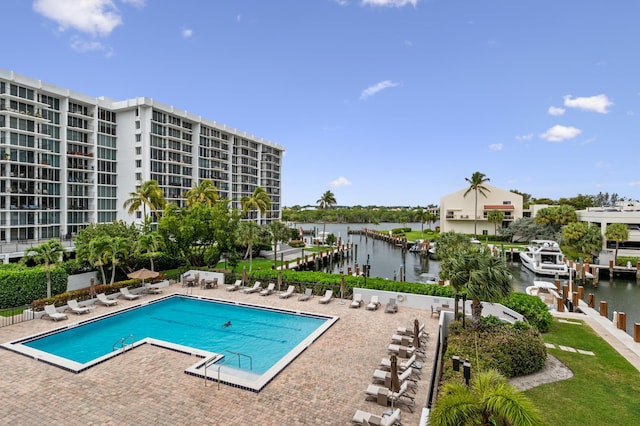 view of swimming pool featuring a patio area and a water view