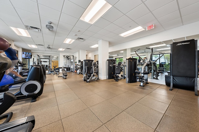 workout area with a paneled ceiling