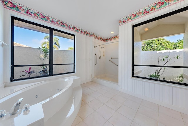 bathroom with separate shower and tub and tile patterned flooring