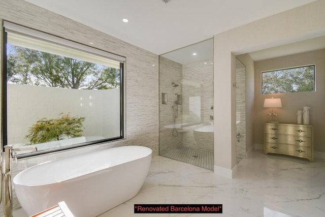 bathroom featuring shower with separate bathtub