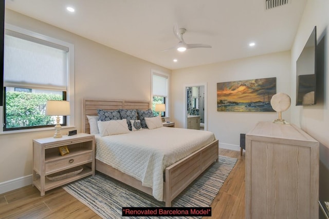 bedroom featuring ensuite bath, light hardwood / wood-style flooring, and ceiling fan