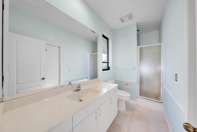 bathroom with vanity, an enclosed shower, toilet, and tile patterned floors